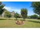 Inviting backyard fire pit offers a cozy gathering spot for relaxation and outdoor enjoyment at 585 Lawton Bridge Sw Rd, Smyrna, GA 30082