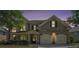 Beautiful home at twilight with brick accents, well-manicured landscaping, and a two-car garage at 585 Lawton Bridge Sw Rd, Smyrna, GA 30082