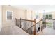 Upper hallway with carpet, ornate wrought iron railing, and light neutral walls at 585 Lawton Bridge Sw Rd, Smyrna, GA 30082