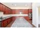 Spacious kitchen with granite counters, stainless appliances, and cherry wood cabinets at 585 Lawton Bridge Sw Rd, Smyrna, GA 30082