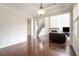 Open-concept living room with hardwood floors and stone fireplace at 585 Lawton Bridge Sw Rd, Smyrna, GA 30082