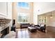 Bright living room boasts tall ceilings, many windows, and stone fireplace at 585 Lawton Bridge Sw Rd, Smyrna, GA 30082