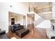 Open-concept living area with fireplace, hardwood floors, and staircase at 585 Lawton Bridge Sw Rd, Smyrna, GA 30082