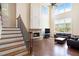 Living room with soaring windows, stone fireplace, and hardwood floors at 585 Lawton Bridge Sw Rd, Smyrna, GA 30082