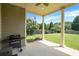 Covered patio featuring ceiling fan, barbecue grill, and view of the spacious and manicured backyard at 585 Lawton Bridge Sw Rd, Smyrna, GA 30082