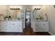 Elegant main bathroom with double vanity and granite counters, offers a luxurious and practical space at 6455 Ivey Meadow Ln, Cumming, GA 30040