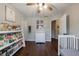 Well-lit room with a crib and bookshelf stocked with reading material at 6455 Ivey Meadow Ln, Cumming, GA 30040