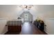 Bright bedroom with a low ceiling and a bed flanked by two storage areas at 6455 Ivey Meadow Ln, Cumming, GA 30040