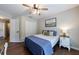 Well-lit bedroom with a full sized bed and two white closets at 6455 Ivey Meadow Ln, Cumming, GA 30040