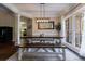 Elegant dining room with modern lighting, large windows, and stylish benches perfect for Gathering meals at 6455 Ivey Meadow Ln, Cumming, GA 30040