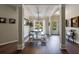 Open concept dining room featuring stylish lighting, neutral decor, and views of the backyard at 6455 Ivey Meadow Ln, Cumming, GA 30040