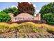 Beautiful brick community sign surrounded by colorful shrubs and flowers in a well-maintained landscape at 6455 Ivey Meadow Ln, Cumming, GA 30040