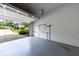 Spacious two-car garage with an open door and epoxy flooring at 6455 Ivey Meadow Ln, Cumming, GA 30040