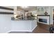 Stylish kitchen with granite counters, white cabinets, stainless appliances, and a fireplace at 6455 Ivey Meadow Ln, Cumming, GA 30040