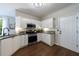 Updated kitchen features sleek stainless steel appliances, granite countertops, and modern white cabinetry at 6455 Ivey Meadow Ln, Cumming, GA 30040
