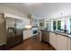 Modern kitchen with stainless steel appliances, granite countertops, white cabinets, and a cozy breakfast nook at 6455 Ivey Meadow Ln, Cumming, GA 30040