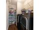 Convenient laundry room with shelving for storage and modern appliances for efficient laundry care at 6455 Ivey Meadow Ln, Cumming, GA 30040