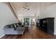 Bright living room with vaulted ceilings, fireplace, hardwood floors, and a comfortable sectional sofa at 6455 Ivey Meadow Ln, Cumming, GA 30040