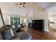 Inviting living room features vaulted ceilings, fireplace, hardwood floors, and a comfortable sectional sofa at 6455 Ivey Meadow Ln, Cumming, GA 30040