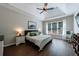 Serene main bedroom with tray ceilings, large window, and neutral decor creating a relaxing retreat at 6455 Ivey Meadow Ln, Cumming, GA 30040