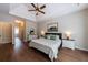 Spacious main bedroom boasts tray ceilings, elegant decor, and wood floors, creating a serene atmosphere at 6455 Ivey Meadow Ln, Cumming, GA 30040
