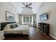 Bright main bedroom with tray ceiling, ceiling fan, and a large window, offers a comfortable retreat at 6455 Ivey Meadow Ln, Cumming, GA 30040