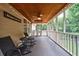 Inviting screened porch with wood ceiling, ceiling fan, and comfortable seating for relaxing outdoors at 6455 Ivey Meadow Ln, Cumming, GA 30040