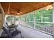 Relaxing screened-in porch with comfortable seating, perfect for enjoying the outdoors in comfort at 6455 Ivey Meadow Ln, Cumming, GA 30040