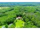 Aerial view of a secluded home surrounded by lush trees and greenery in a private and serene setting at 6919 Mount Zion Rd, Waco, GA 30182