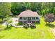 Aerial view of home featuring front porch, brick foundation, and in-ground pool at 6919 Mount Zion Rd, Waco, GA 30182
