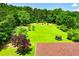 Large, grassy backyard featuring mature trees and a trampoline at 6919 Mount Zion Rd, Waco, GA 30182