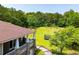 View of large backyard with trampoline and covered porch at 6919 Mount Zion Rd, Waco, GA 30182