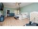 Large bedroom featuring laminate floors, soft green walls, and a comfortable bed at 6919 Mount Zion Rd, Waco, GA 30182