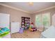 Bedroom with wood floors, organized closet with clothes, and natural light at 6919 Mount Zion Rd, Waco, GA 30182