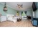 Relaxing bedroom with laminate floors, soft green walls, and natural light at 6919 Mount Zion Rd, Waco, GA 30182
