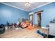 Blue bedroom with ceiling fan, patterned bedding, and filled with toys at 6919 Mount Zion Rd, Waco, GA 30182