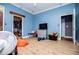 Blue bedroom with ceiling fan and an open closet with clothes at 6919 Mount Zion Rd, Waco, GA 30182