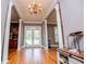 Spacious entryway featuring hardwood floors, decorative chandelier and views into the backyard at 6919 Mount Zion Rd, Waco, GA 30182