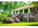Inviting exterior view featuring a charming front porch with stone accents and well-maintained landscaping at 6919 Mount Zion Rd, Waco, GA 30182