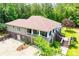 Expansive home featuring a brick foundation, sprawling porch, and lush greenery at 6919 Mount Zion Rd, Waco, GA 30182