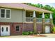 Charming home with a covered porch featuring stone and brick accents, perfect for outdoor living at 6919 Mount Zion Rd, Waco, GA 30182