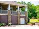 Exterior view showcasing stone and brick accents on a home's porch with a charming garage entrance at 6919 Mount Zion Rd, Waco, GA 30182
