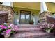 Charming front entrance with brick stairs, decorative flower pots, and stylish outdoor lanterns at 6919 Mount Zion Rd, Waco, GA 30182