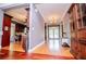 Bright hallway featuring wood floors, chandelier, and an open view into the kitchen area at 6919 Mount Zion Rd, Waco, GA 30182