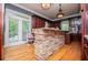 An eat-in kitchen featuring wood cabinets, stainless appliances, and a stone-clad breakfast bar at 6919 Mount Zion Rd, Waco, GA 30182