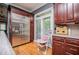 A stainless steel refrigerator complements the wood cabinets and hardwood floors in this kitchen at 6919 Mount Zion Rd, Waco, GA 30182