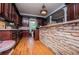 A spacious kitchen with stainless appliances, wood cabinets, stone-clad breakfast bar and hardwood floors at 6919 Mount Zion Rd, Waco, GA 30182