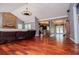 Open-concept living room showcasing hardwood floors, a stone fireplace, and access to the kitchen at 6919 Mount Zion Rd, Waco, GA 30182