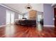 Spacious living room featuring hardwood floors, stone fireplace, and a chandelier at 6919 Mount Zion Rd, Waco, GA 30182