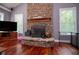 Cozy living room with a stone fireplace, built-in shelving and large windows at 6919 Mount Zion Rd, Waco, GA 30182